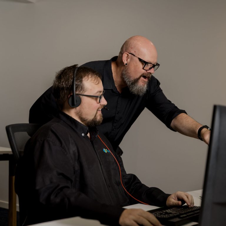 Two IT Leaders technicians working at a computer.