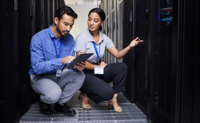 a man and woman in a server room